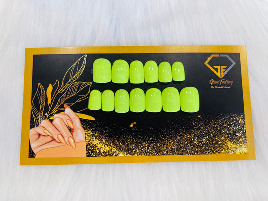 A set of green press-on nails displayed on a flare card with a glamorous design and the GlamFactory logo.